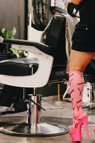 Three stylists in black skipping down a sunny sidewalk wearing pink Salongevity compression socks